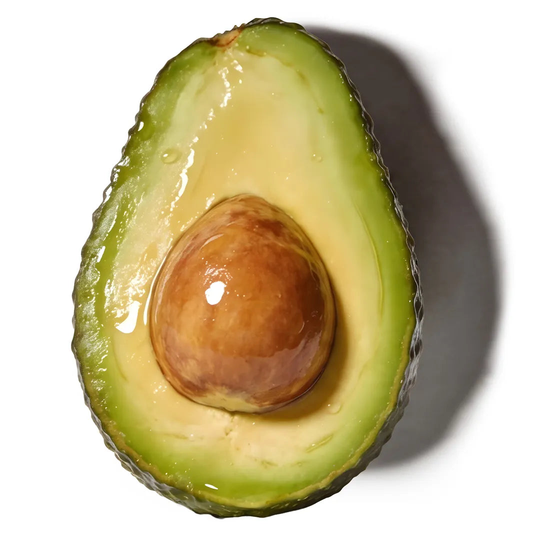 Halved avocado with a natural oil sheen on a clean white background, representing Yelf Clean Affairs Cleansing Milk ingredients