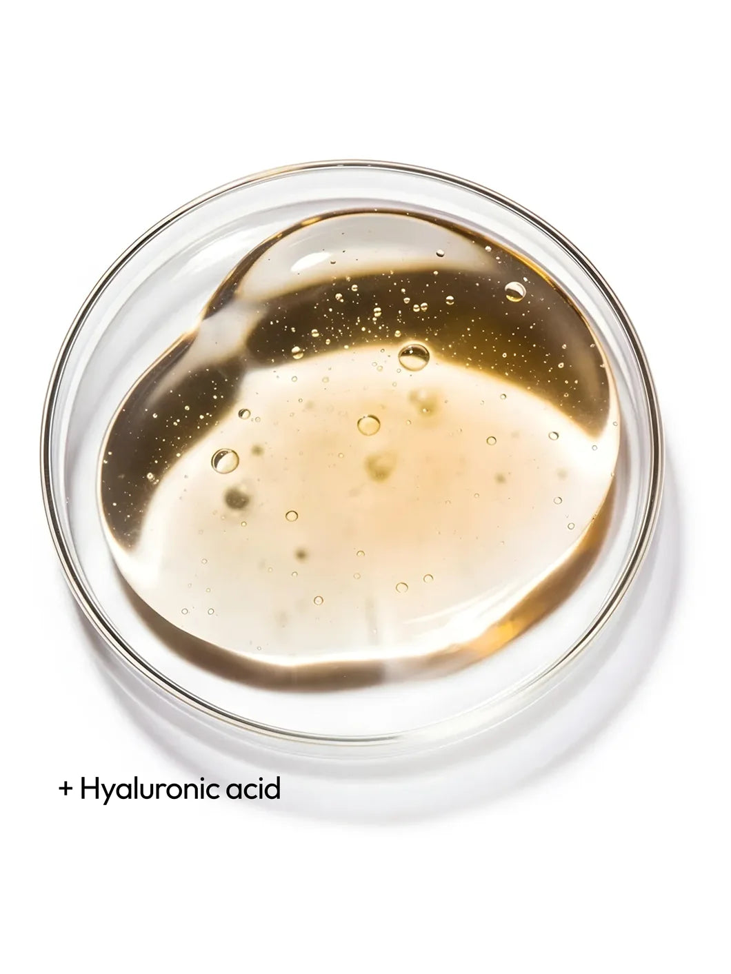 Top view of a clear liquid with fine bubbles in a petri dish, illustrating hyaluronic acid as a key hydration ingredient used in Yelf Hyaluron Day Cream
