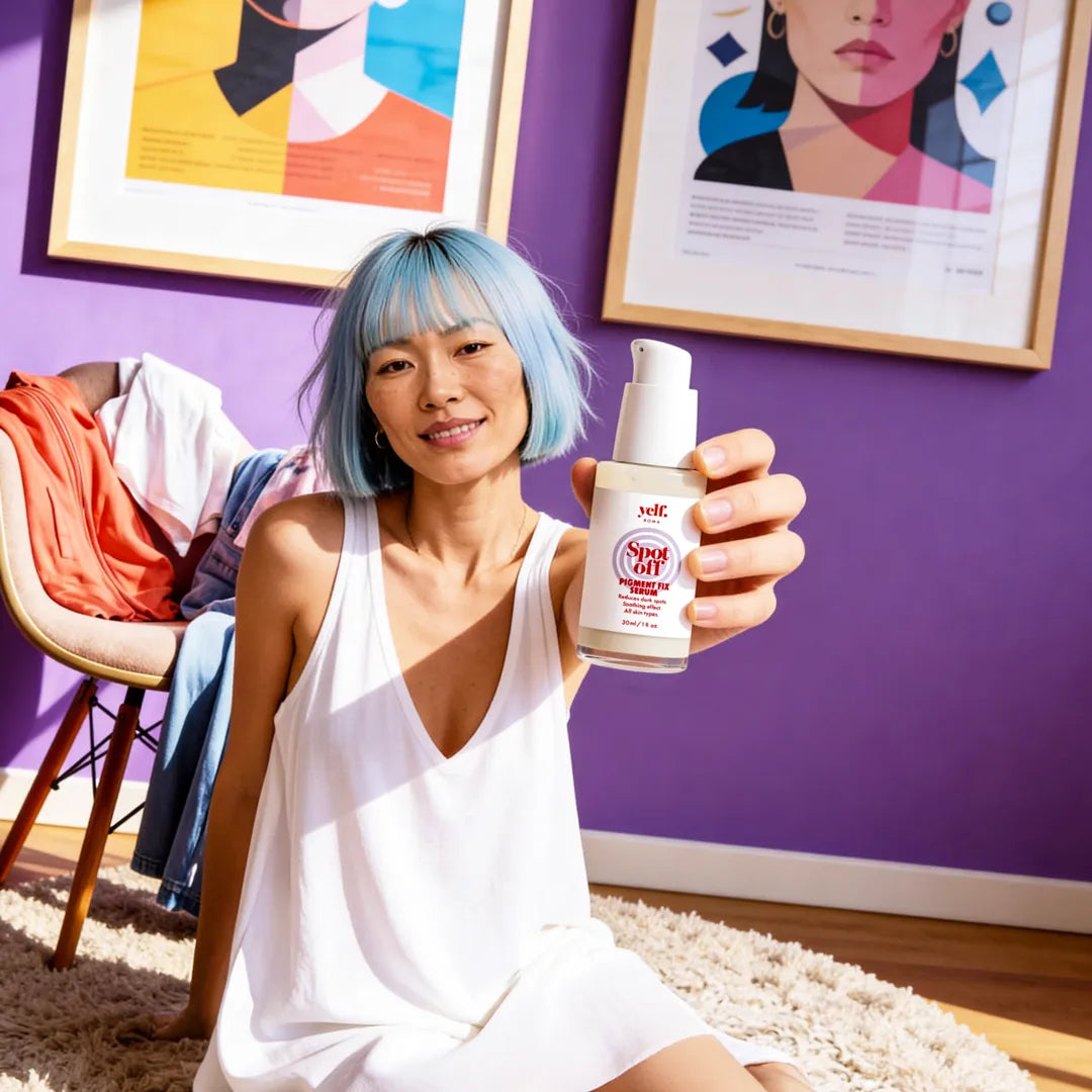 Model holding Yelf Spot Off Pigment Fix Serum in a colorful modern interior with purple walls, warm sunlight and relaxed contemporary skincare atmosphere.
