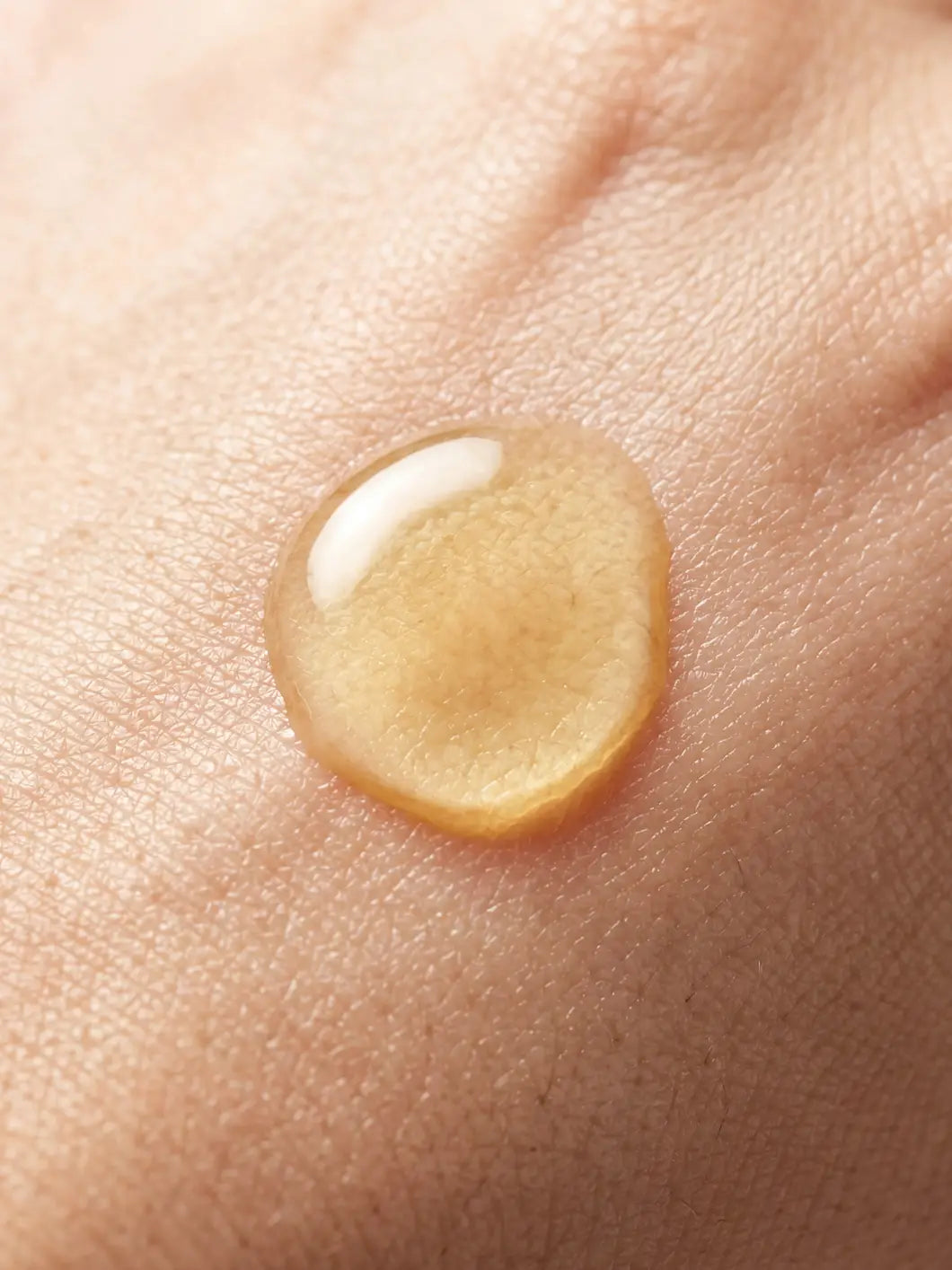 Yelf Viva el Boost Cannabidiol Oil – golden oil droplet applied on skin in close-up