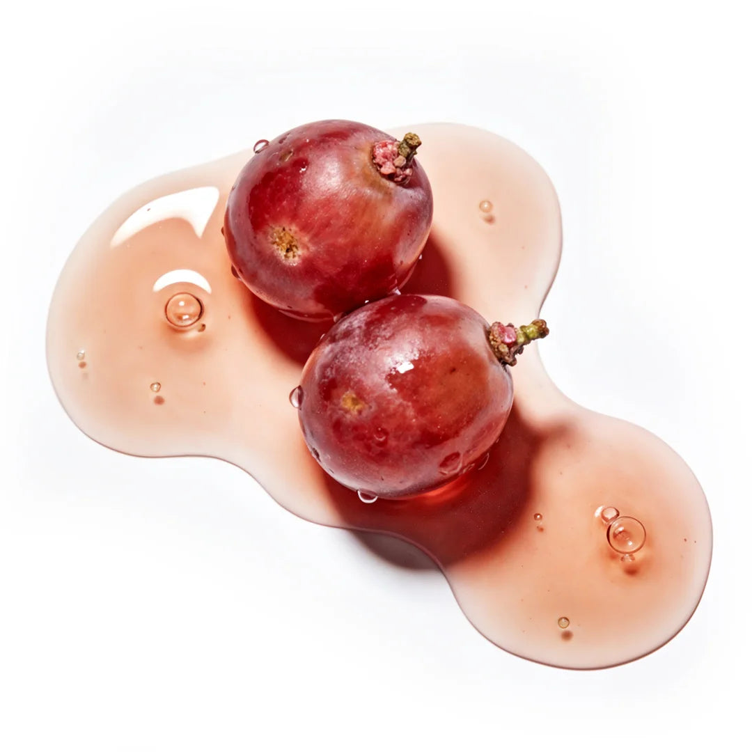 Yelf Viva el Boost Ginkgo Gel shown with natural red grapes surrounded by a glossy red-brown gel texture with small bubbles, bright studio lighting, minimal skincare aesthetic